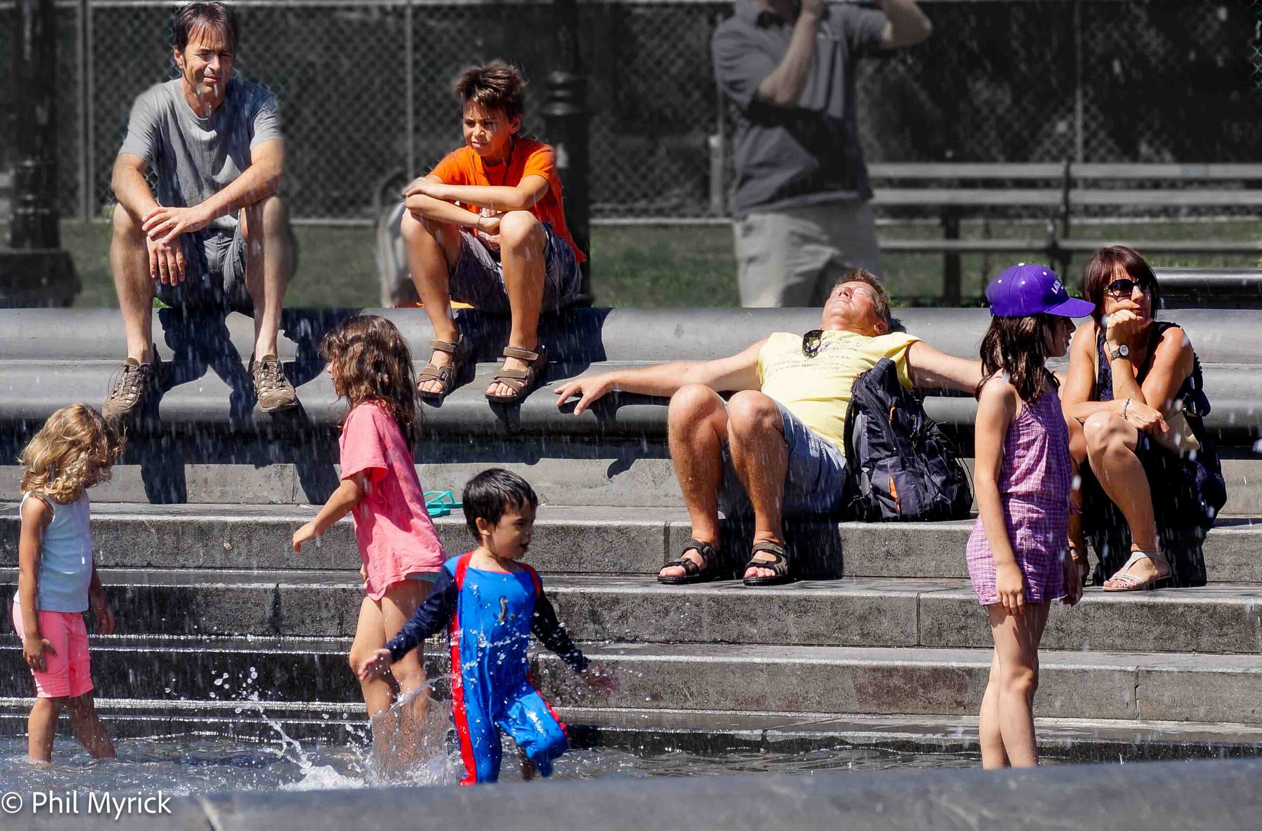 Children playing around a fountain